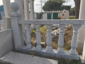 Balaustrada torneada en granito gris Cadalso con acabado aserrado, diseño clásico y duradero.